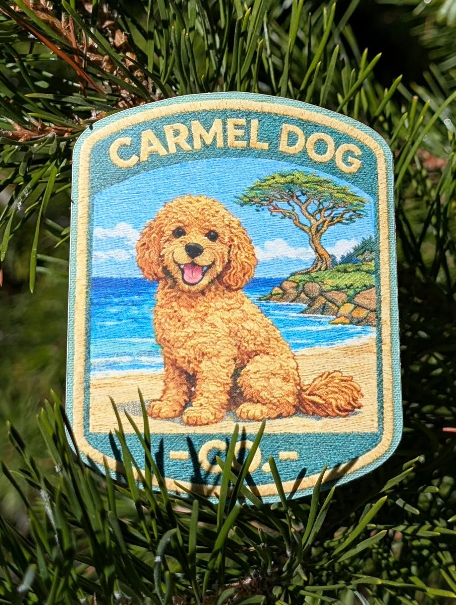 Penny apricot doodle sticker with a beach and cypress tree design, displayed among evergreen branches.