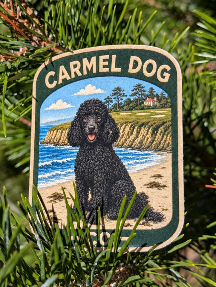 Gatsby black poodle sticker with a coastal cliff and ocean design, displayed among evergreen branches.